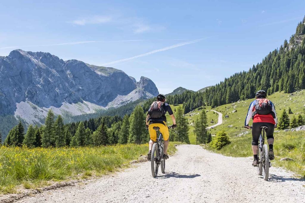 Couple of tourists cycling in the Dolomites